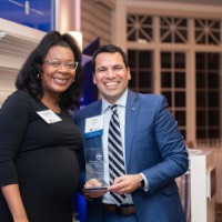 Victor Cardenas smiling with woman who introduced his award